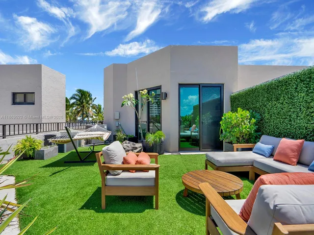 a balcony with outdoor seating and plants