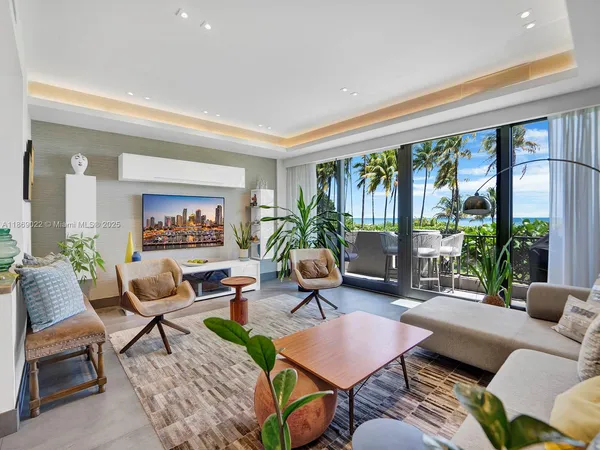 a living room with furniture and a floor to ceiling window