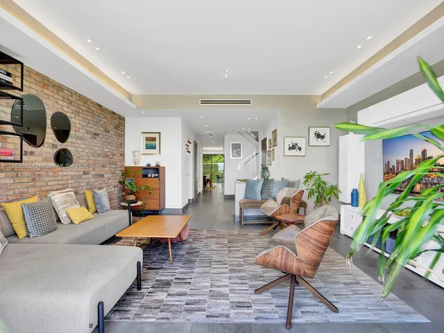 a living room with furniture and stairs