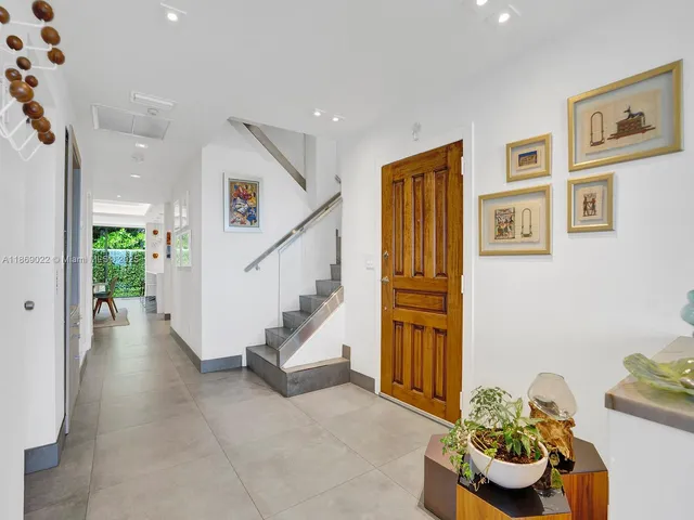 a dining room with furniture and a floor to ceiling window
