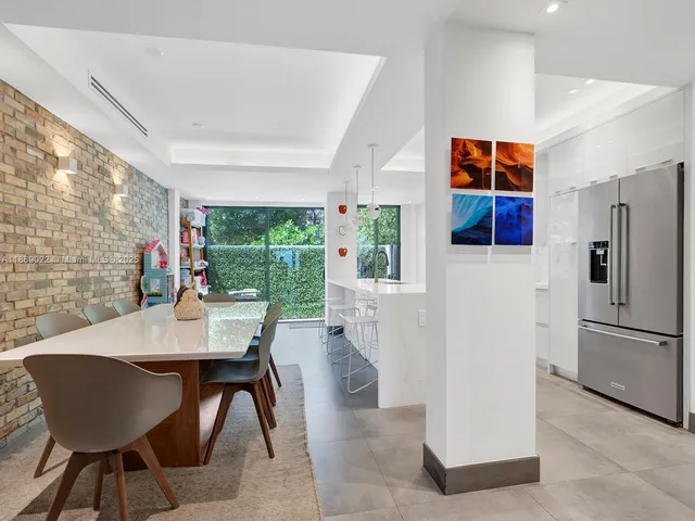 a view of hallway with furniture and windows