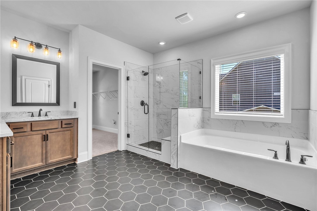226 Holly Br Road Piedmont, SC 29673 - Photo 22 of 44 Modern primary bath showcasing a spacious soaking tub and an oversized shower with seamless glass.