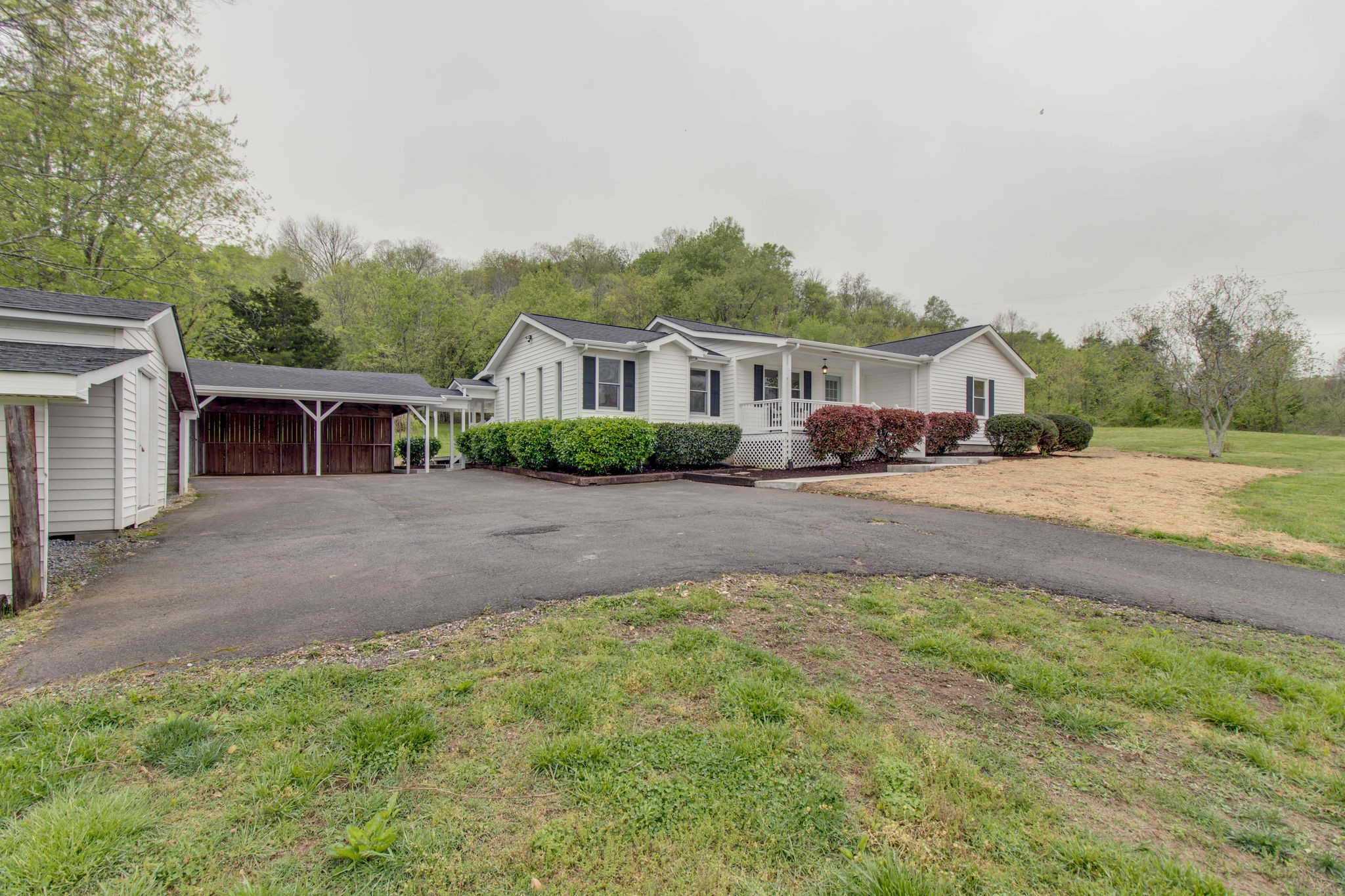 3990 Fairview Road Columbia, TN 38401 - Photo 3 of 29 a front view of a house with a yard and trees