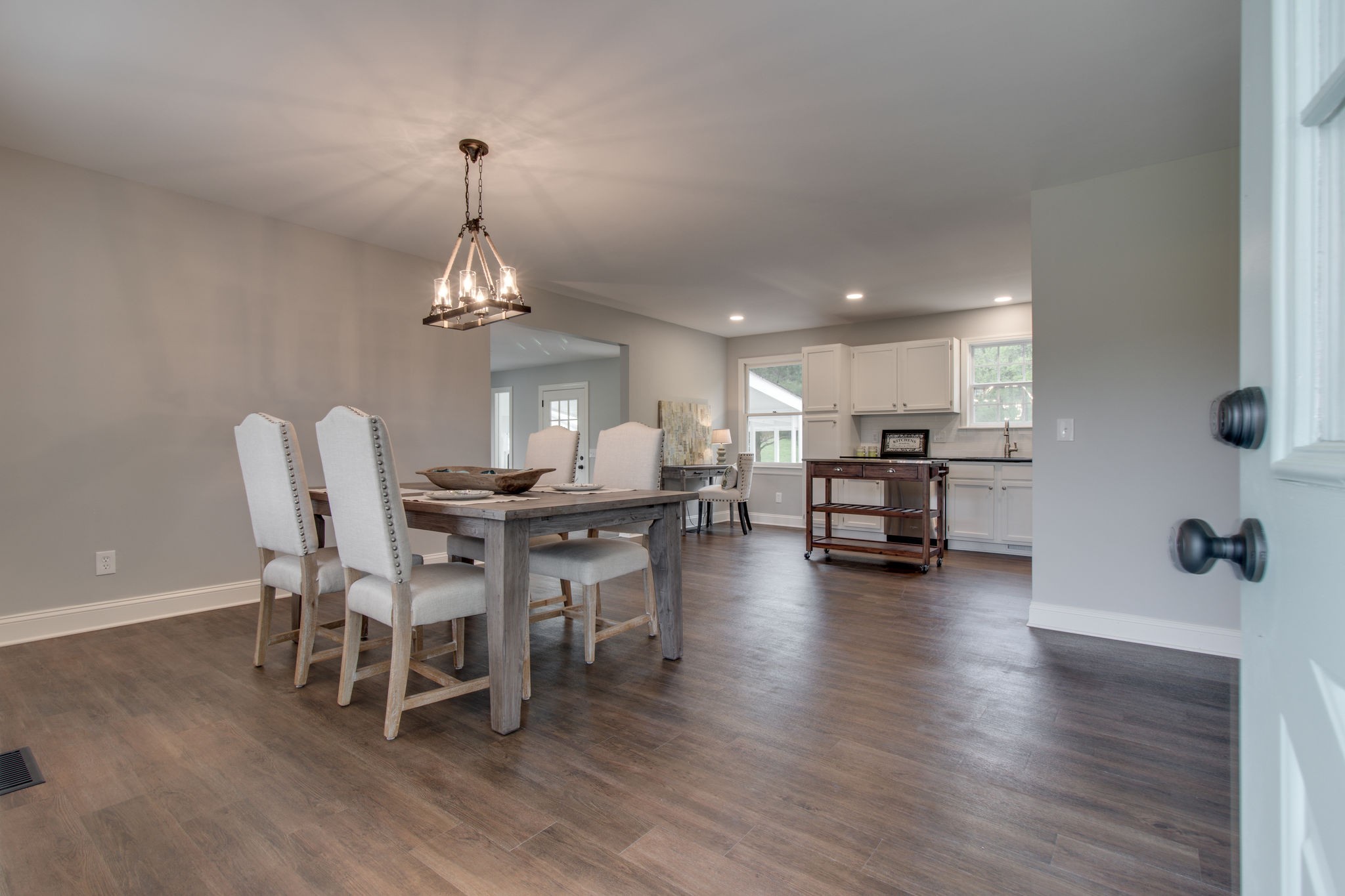 3990 Fairview Road Columbia, TN 38401 - Photo 4 of 29 a dining room with wooden floor a chandelier a glass table and chairs