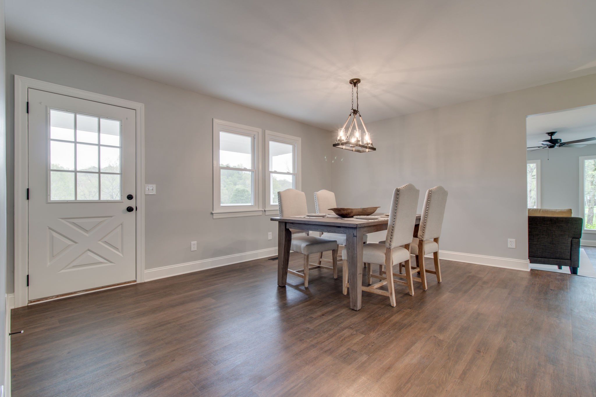 3990 Fairview Road Columbia, TN 38401 - Photo 5 of 29 a dining room with wooden floor a chandelier a wooden table and chairs