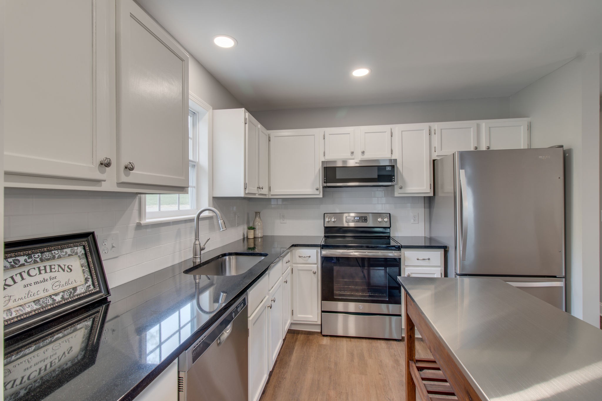 3990 Fairview Road Columbia, TN 38401 - Photo 8 of 29 a kitchen with stainless steel appliances a refrigerator a stove a sink and white cabinets