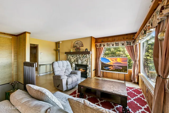 a living room with furniture fireplace and rug