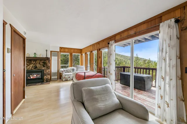 a living room with furniture large window and a flat screen tv