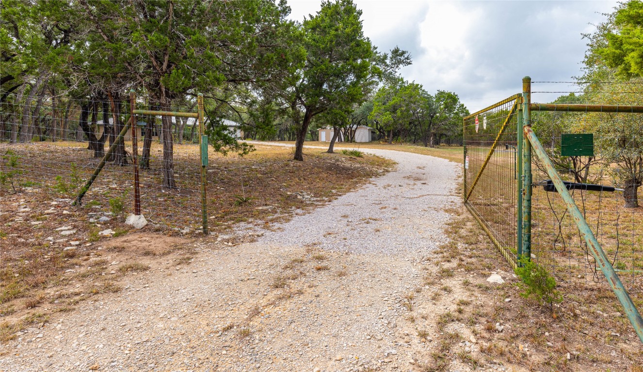 2501 Fischer Store Road Wimberley, TX 78676 - Photo 5 of 37 View of dirt / gravel road with a gated entry