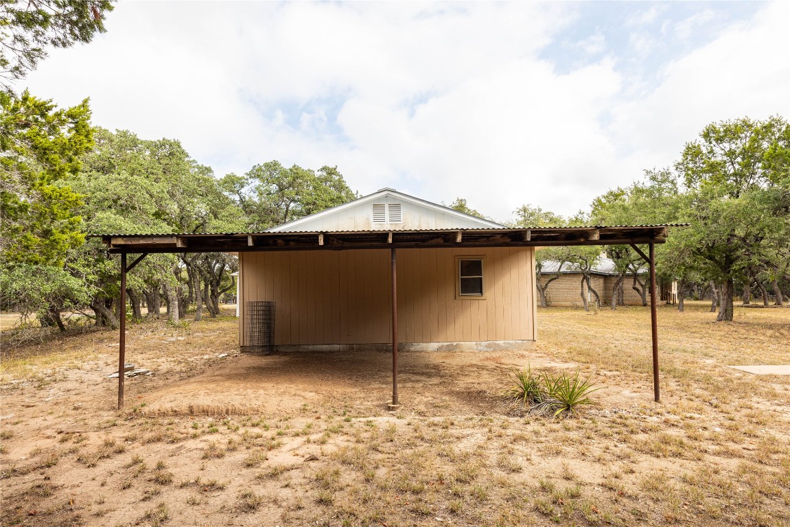 2501 Fischer Store Road Wimberley, TX 78676 - Photo 8 of 37 View of home's exterior with a pole building, an outbuilding, and a carport