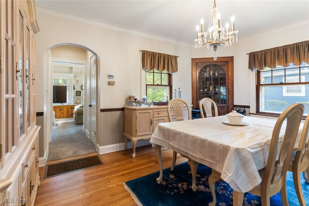 3521 Hopkins Road Youngstown, OH 44511 - Photo 15 of 31 Dining room with ornamental molding, light hardwood / wood-style flooring, and a notable chandelier