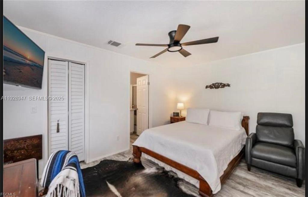2638 Ortona Locks Road Moore Haven, FL 33471 - Photo 12 of 14 a bedroom with a bed and a chair