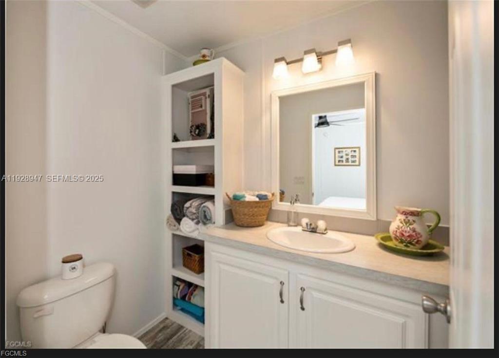 2638 Ortona Locks Road Moore Haven, FL 33471 - Photo 14 of 14 a bathroom with a granite countertop sink and a mirror
