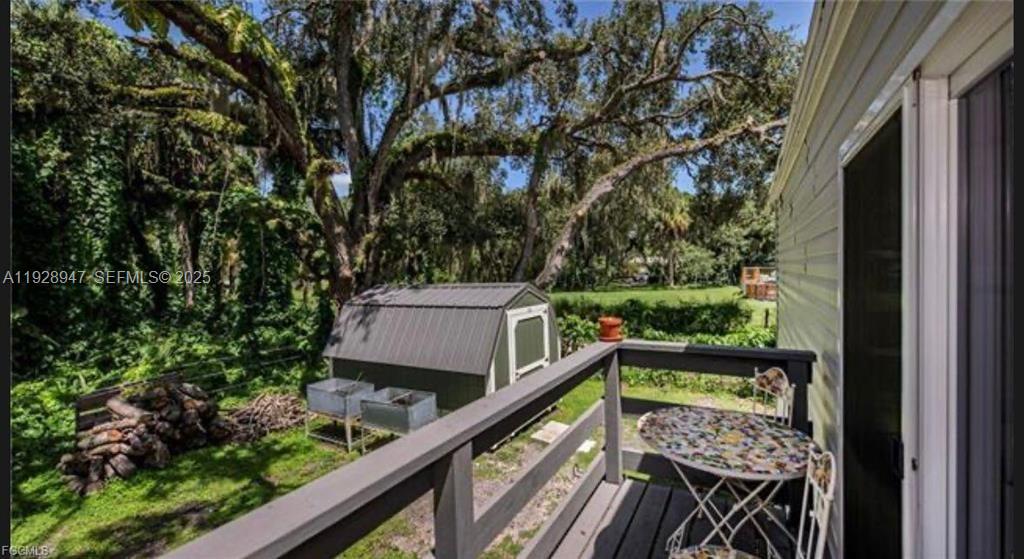 2638 Ortona Locks Road Moore Haven, FL 33471 - Photo 3 of 14 a view of balcony with wooden floor and fence