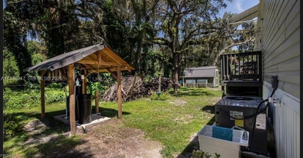 2638 Ortona Locks Road Moore Haven, FL 33471 - Photo 4 of 14 a front view of a house with garden