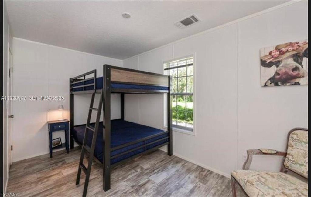 2638 Ortona Locks Road Moore Haven, FL 33471 - Photo 5 of 14 a bedroom with a bed and a window