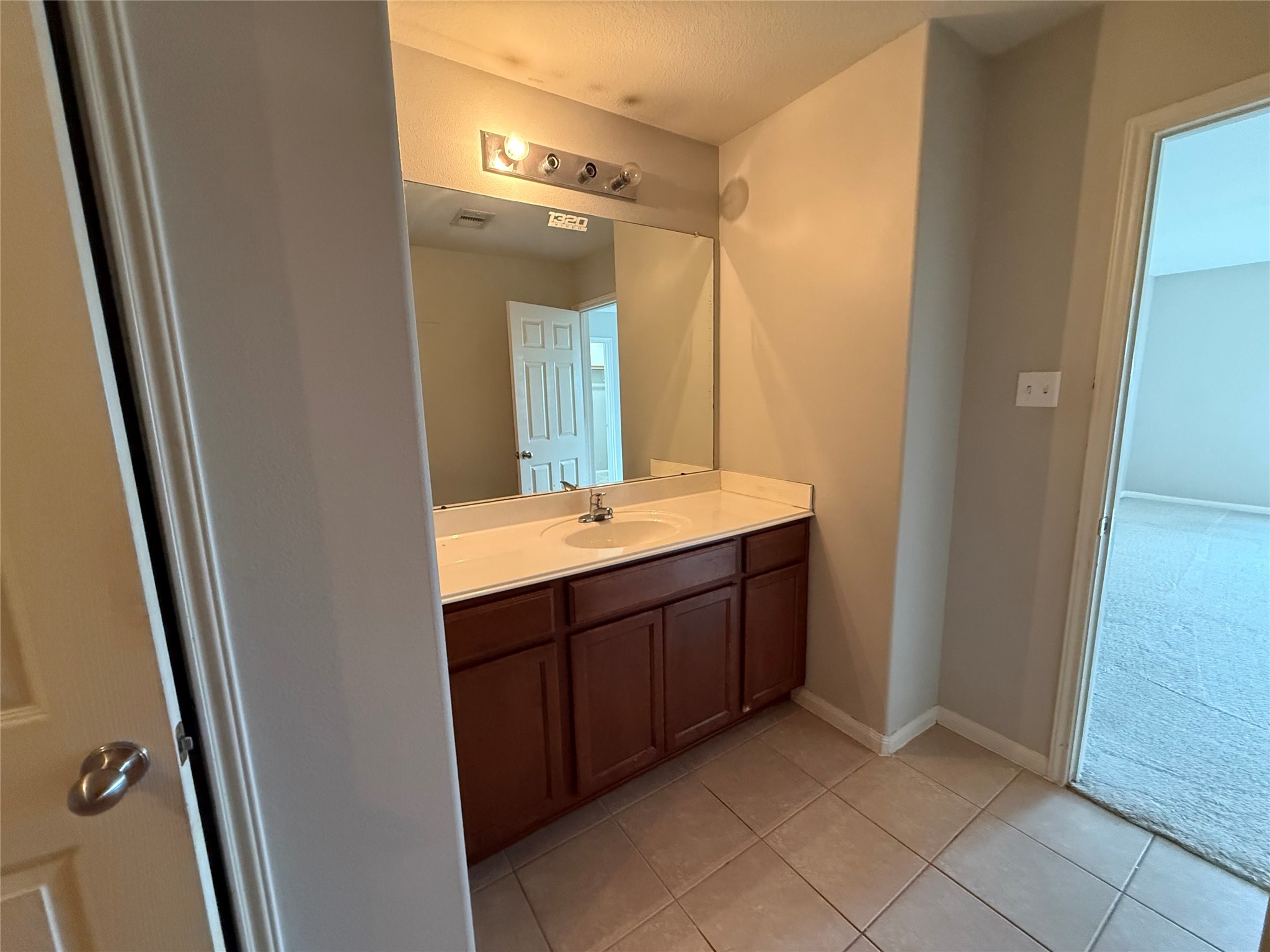 10208 Jewel Court Conroe, TX 77385 - Photo 15 of 23 a bathroom with a double vanity sink and mirror