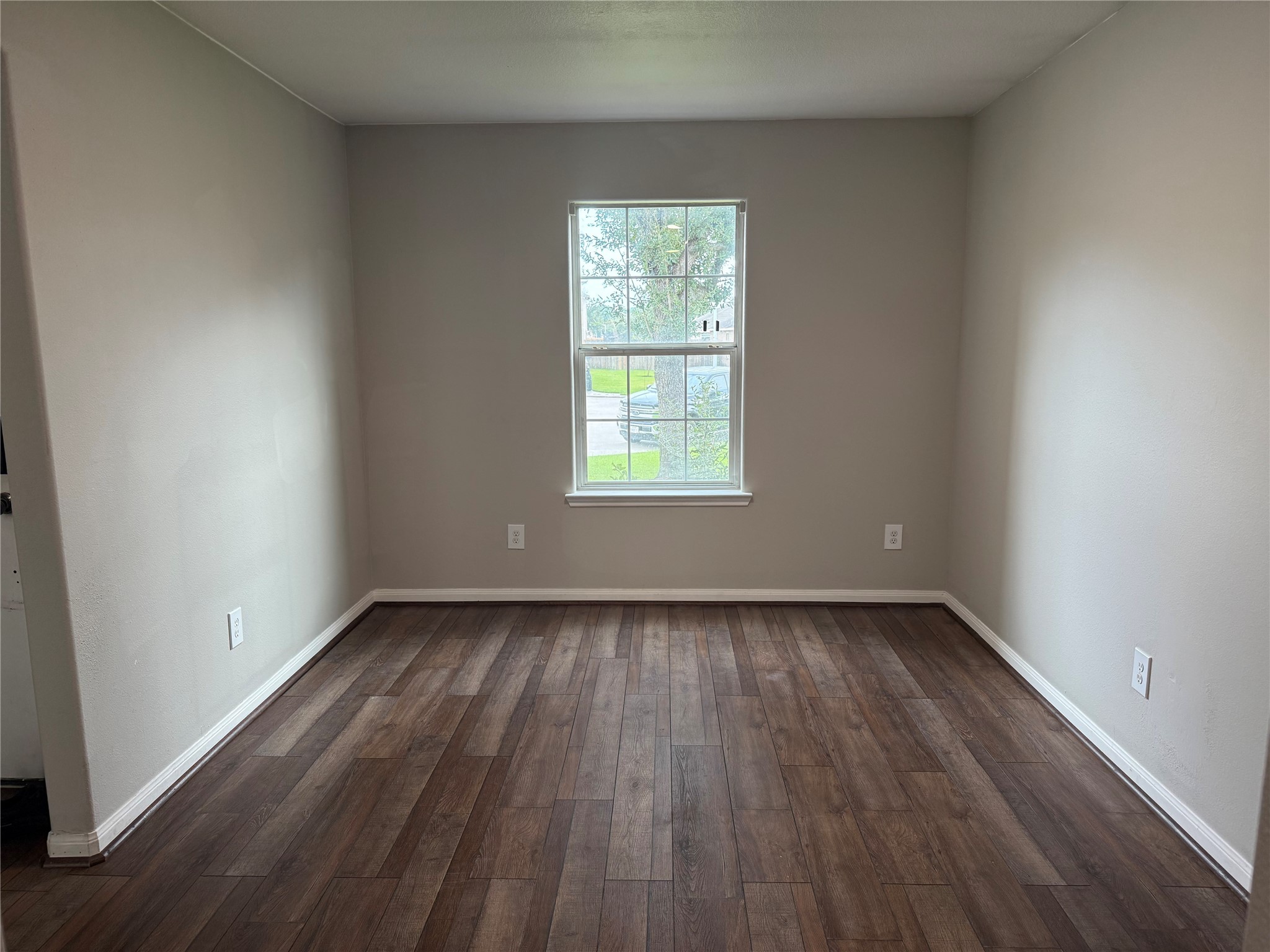 10208 Jewel Court Conroe, TX 77385 - Photo 4 of 23 an empty room with wooden floor and windows