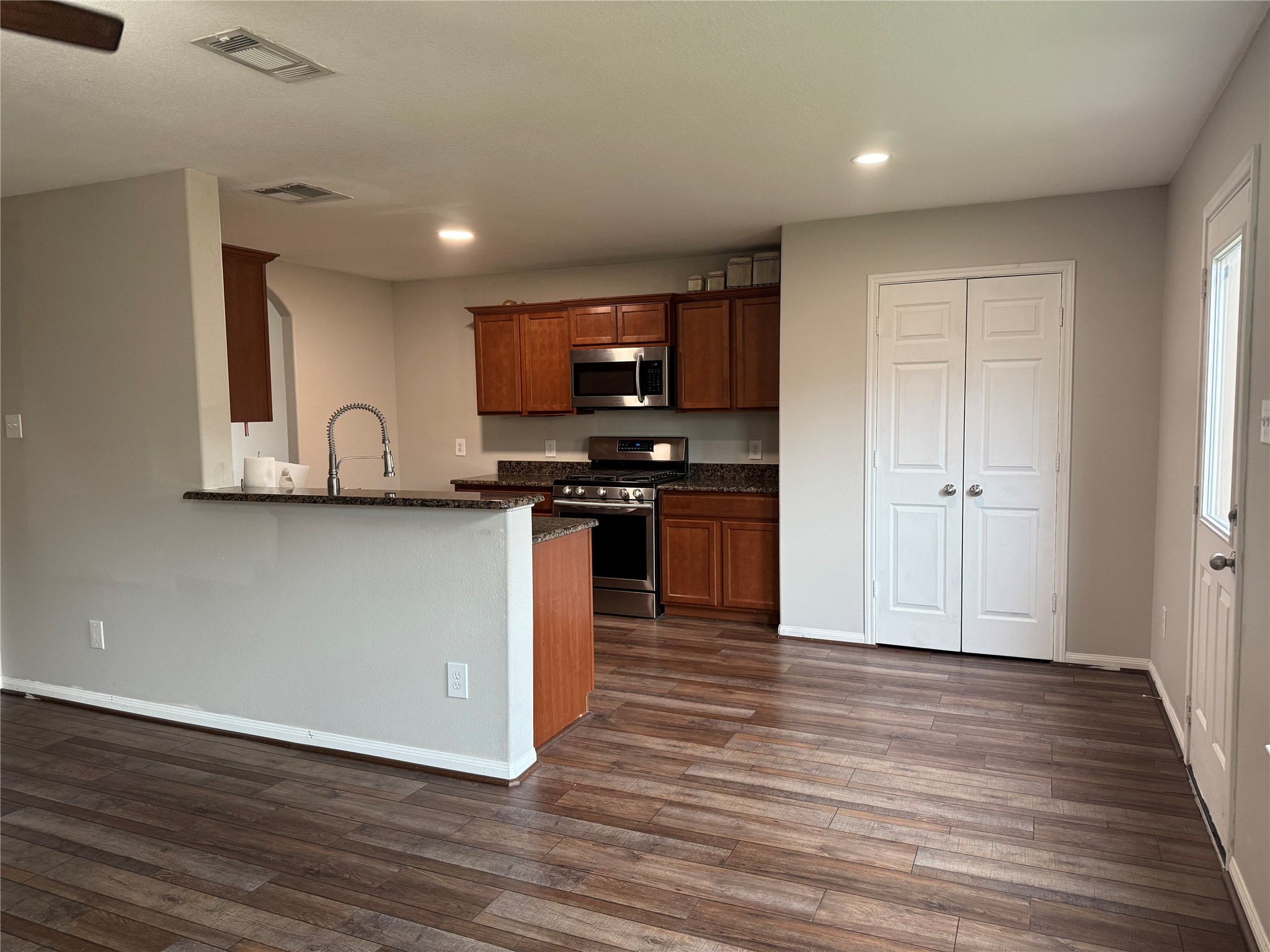 10208 Jewel Court Conroe, TX 77385 - Photo 6 of 23 a view of kitchen with wooden floor and electronic appliances