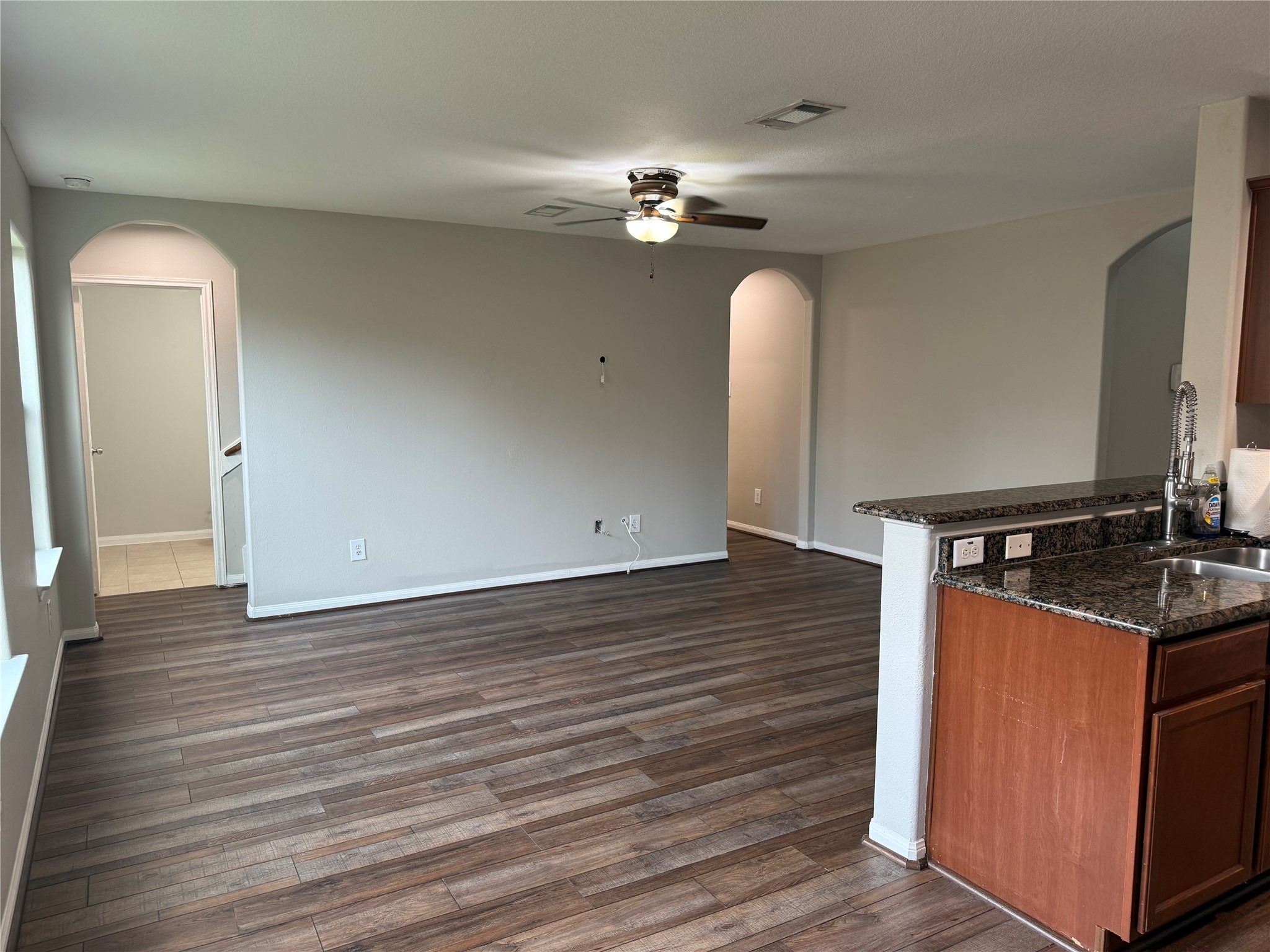 10208 Jewel Court Conroe, TX 77385 - Photo 7 of 23 a hallway with a chandelier and wooden floor