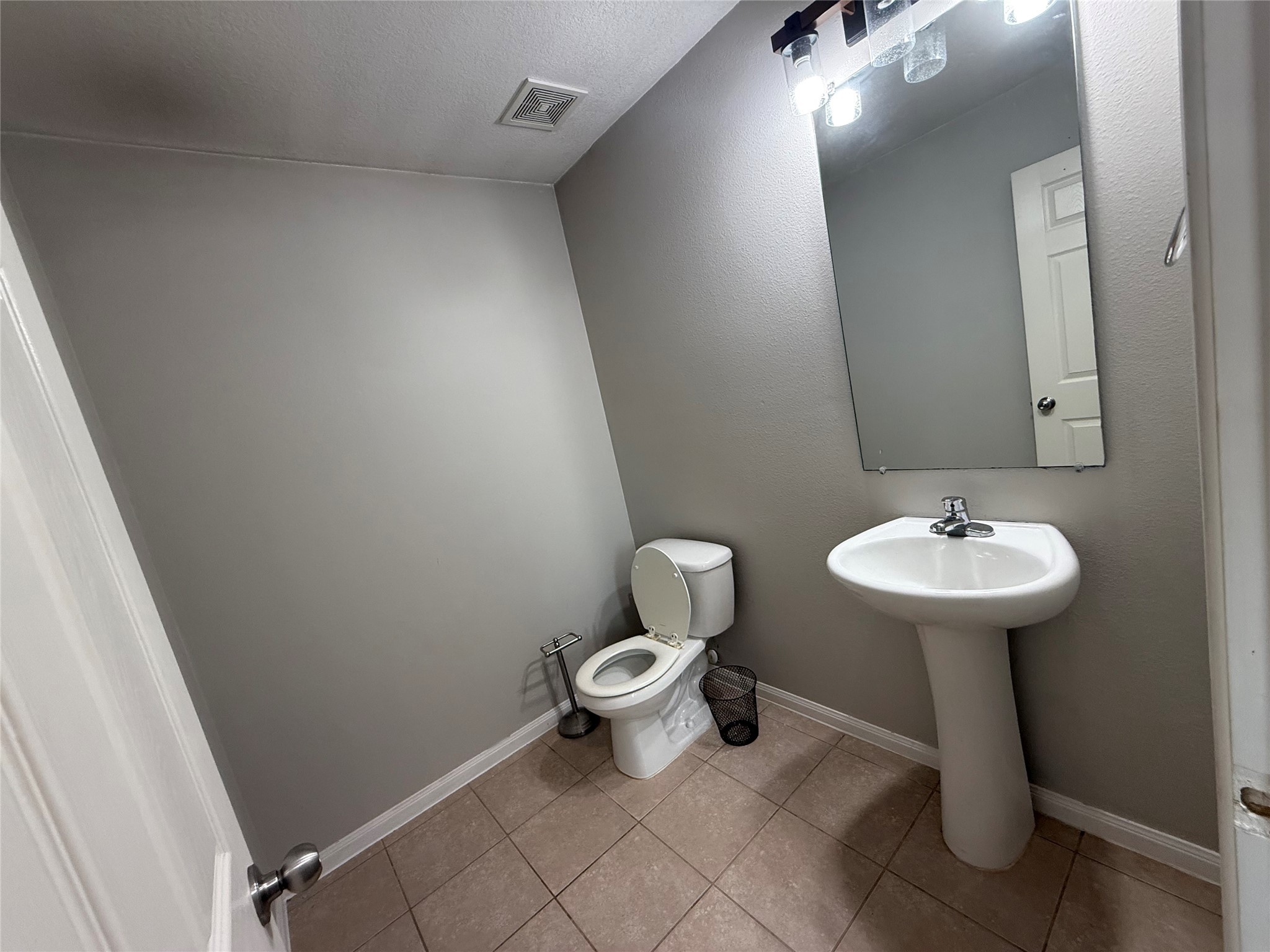 10208 Jewel Court Conroe, TX 77385 - Photo 8 of 23 a bathroom with a sink toilet and a mirror