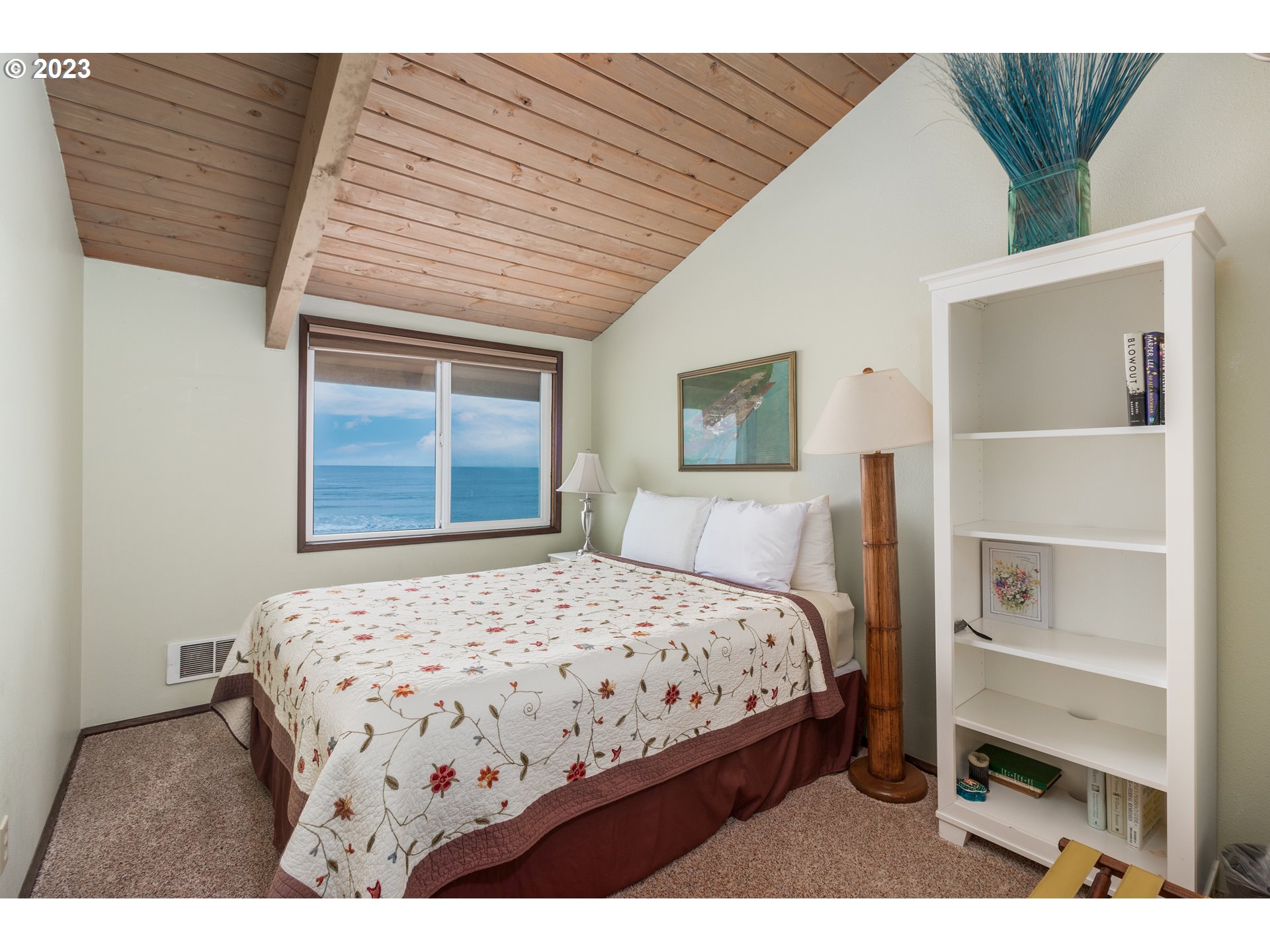 48060 Breakers Boulevard, Unit 2 Neskowin, OR 97149 - Photo 12 of 26 a bedroom with a bed and a window