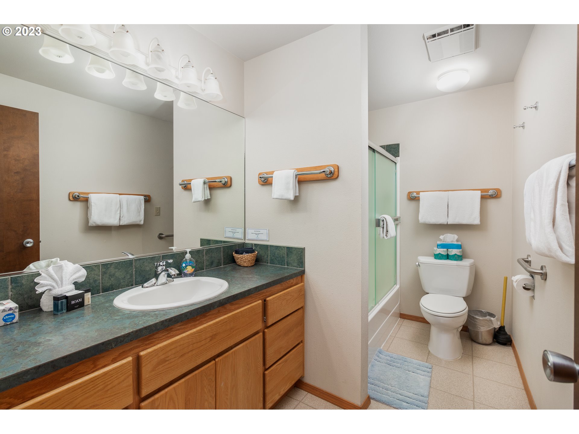 48060 Breakers Boulevard, Unit 2 Neskowin, OR 97149 - Photo 13 of 26 a bathroom with a granite countertop sink mirror a toilet and a shower