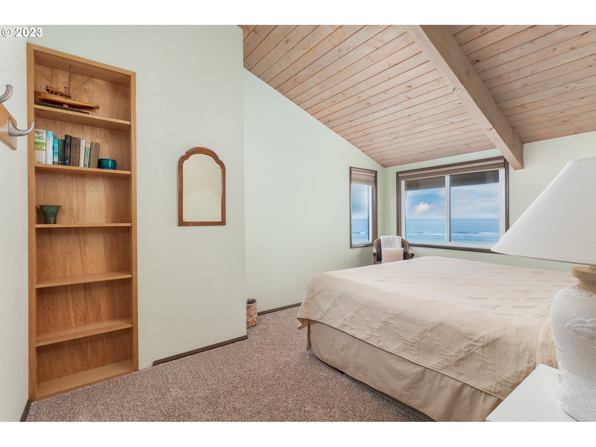 48060 Breakers Boulevard, Unit 2 Neskowin, OR 97149 - Photo 14 of 26 a bedroom with a bed and a large window
