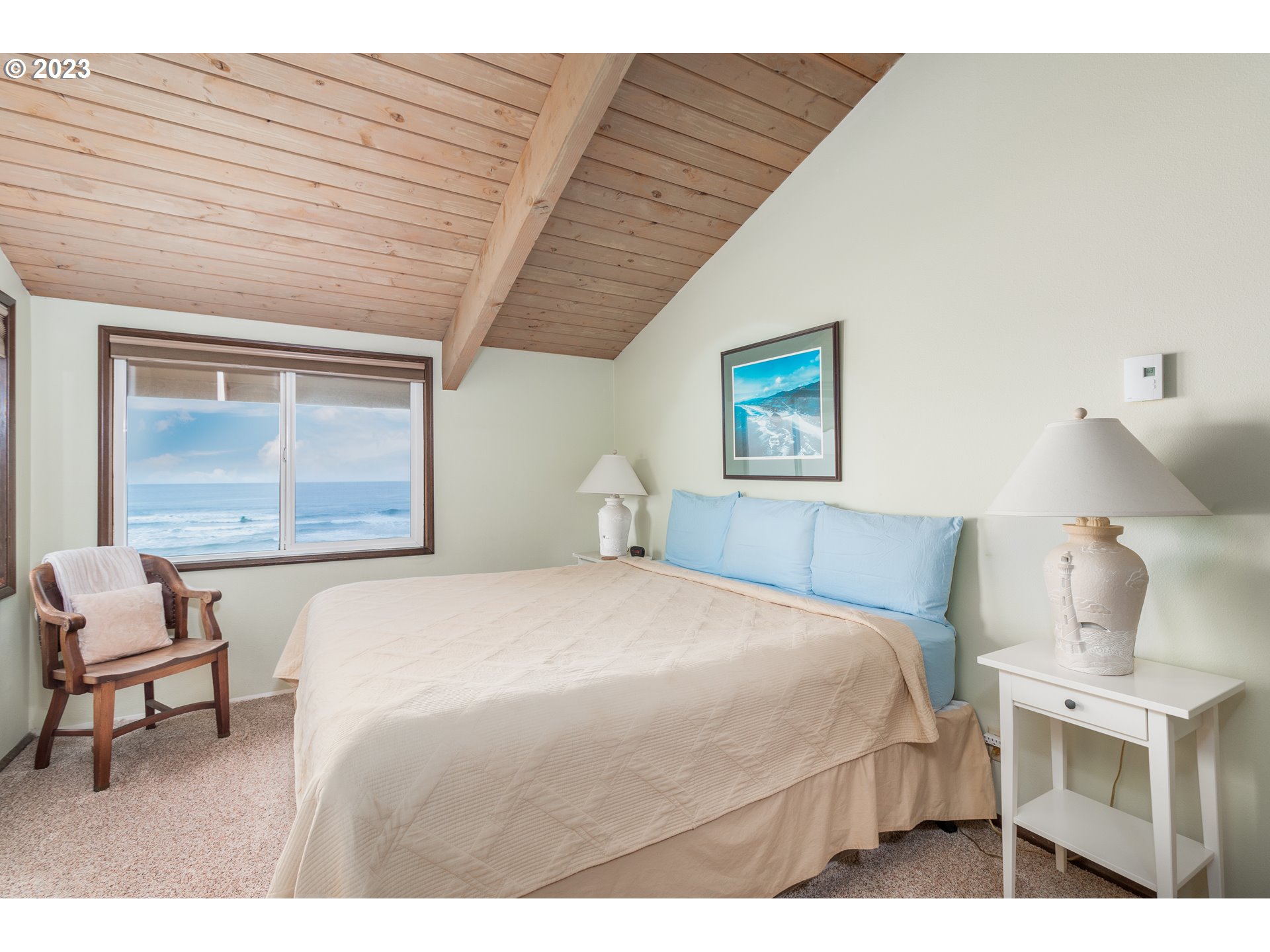 48060 Breakers Boulevard, Unit 2 Neskowin, OR 97149 - Photo 15 of 26 a bedroom with a bed and a chair