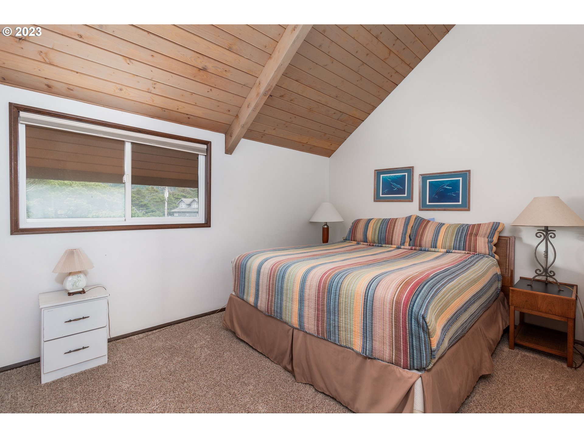 48060 Breakers Boulevard, Unit 2 Neskowin, OR 97149 - Photo 17 of 26 a bedroom with a bed and a cabinets