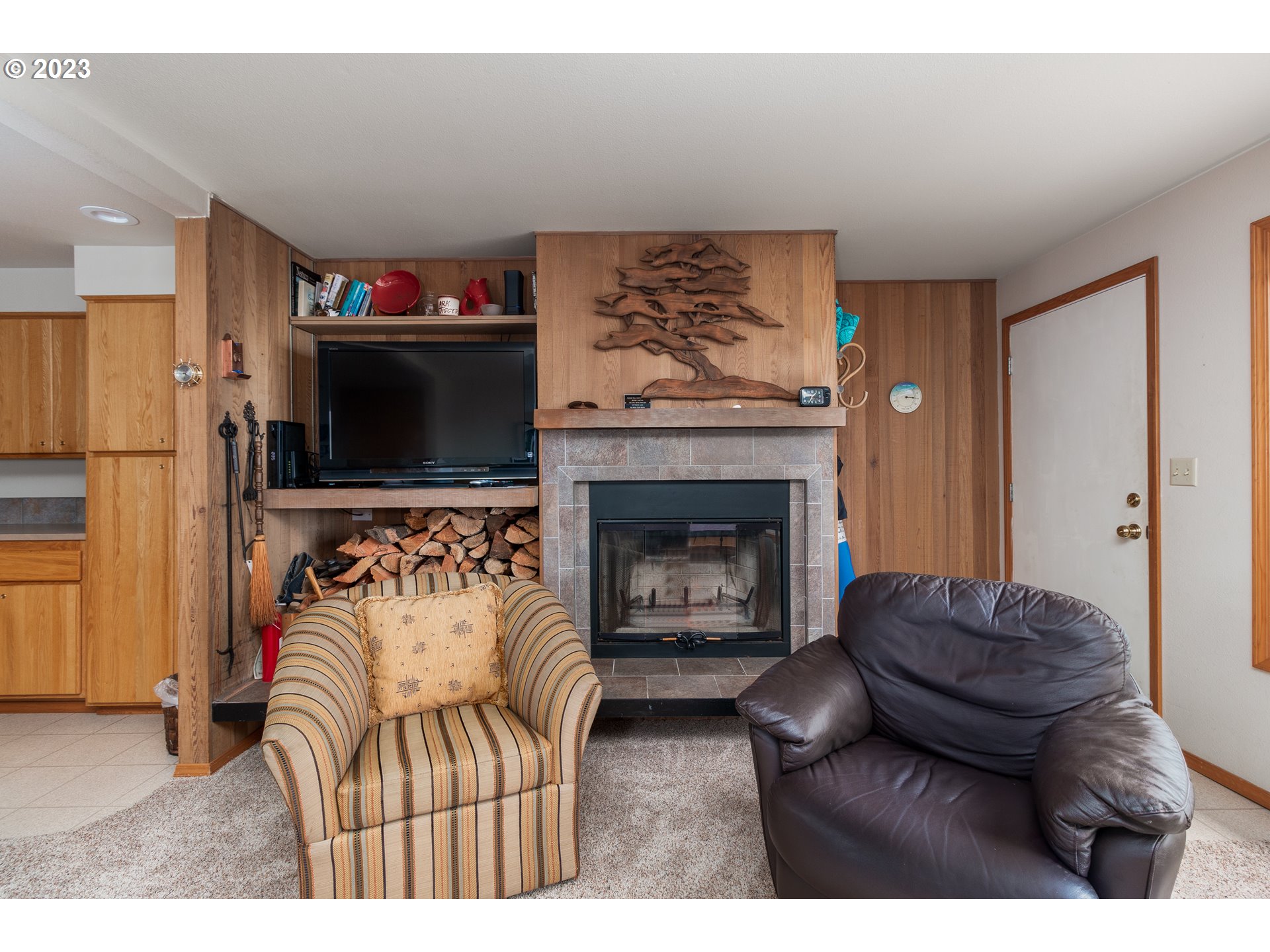 48060 Breakers Boulevard, Unit 2 Neskowin, OR 97149 - Photo 6 of 26 a living room with furniture a flat screen tv and a fireplace