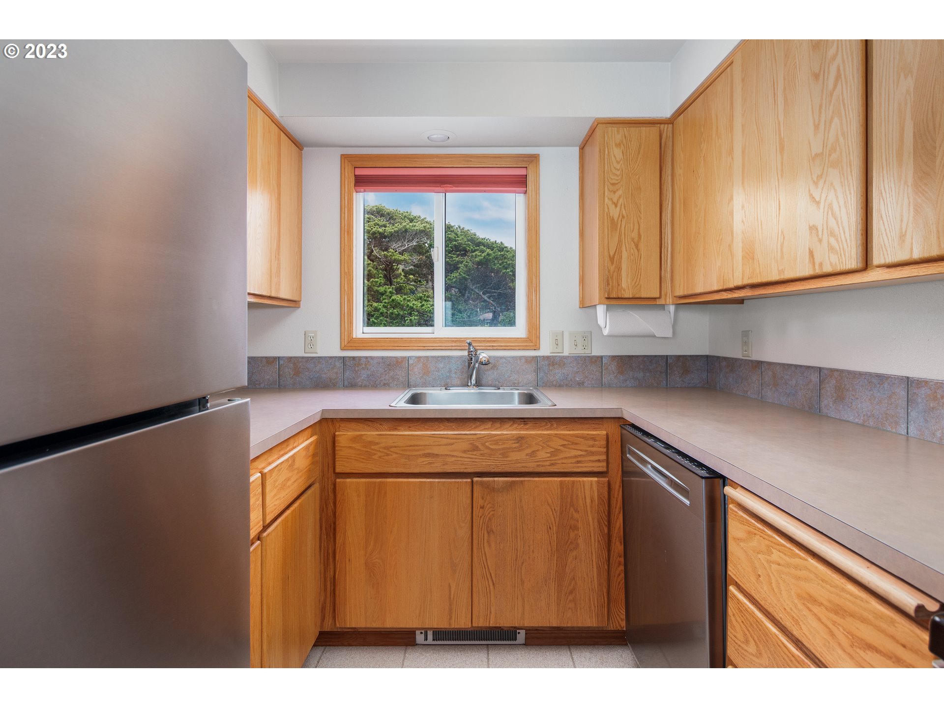 48060 Breakers Boulevard, Unit 2 Neskowin, OR 97149 - Photo 10 of 26 a kitchen with a sink and cabinets