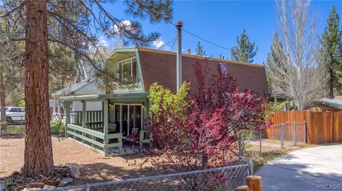 front view of a house with a tree