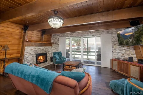 a living room with fireplace furniture and a flat screen tv