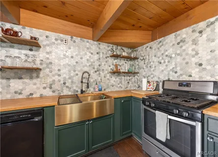 a kitchen with granite countertop a sink and a stove top oven