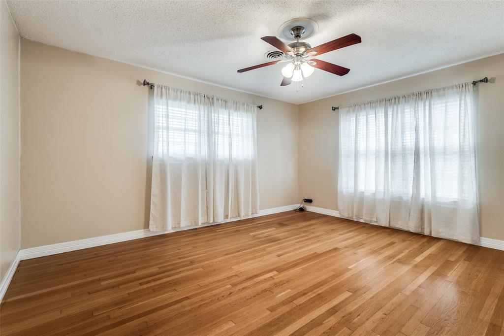 433 Fulton Street Denton, TX 76201 - Photo 14 of 25 an empty room with wooden floor and windows