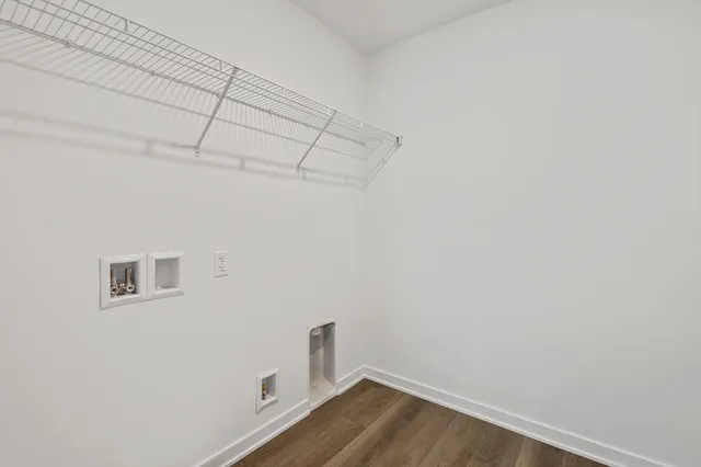 a view of a room with wooden floor