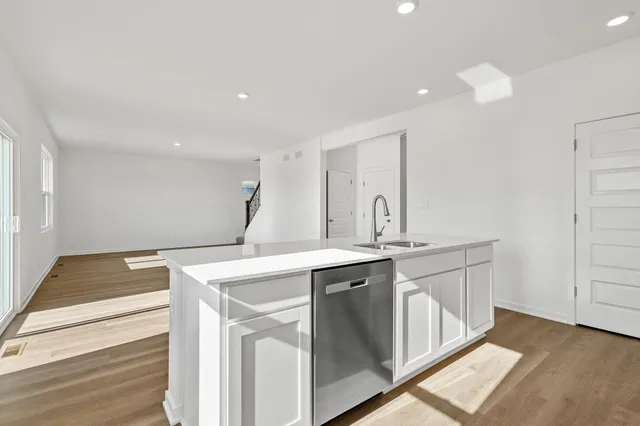 a kitchen with a sink and a stove top oven