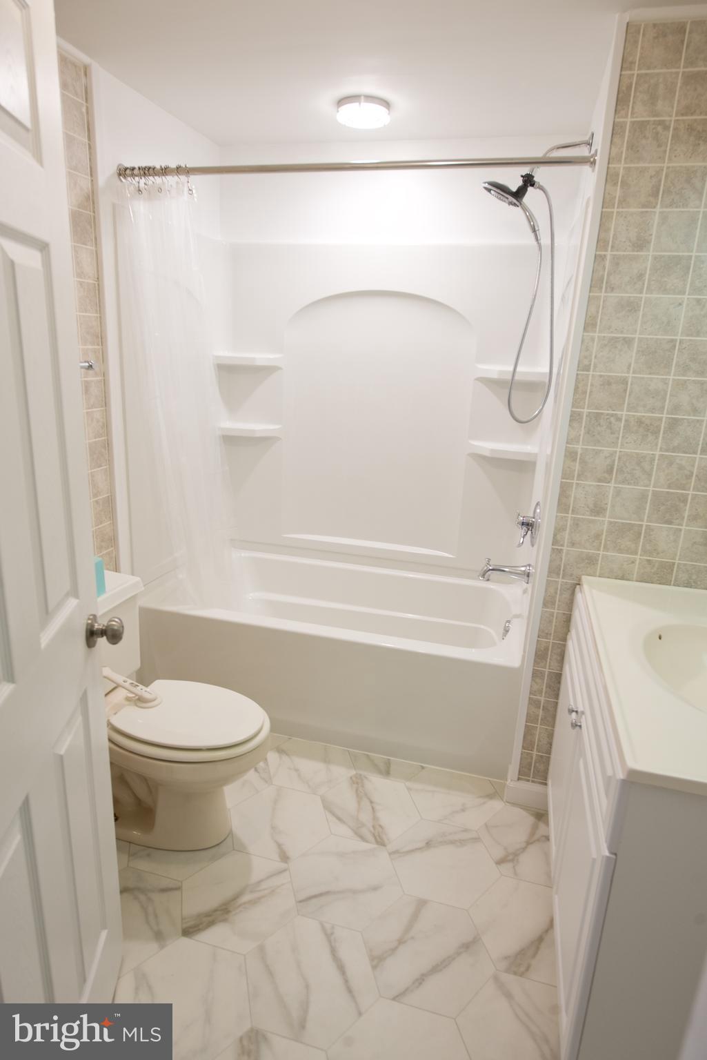 22261 Point Lookout Road Leonardtown, MD 20650 - Photo 17 of 33 Hall Bathroom with new tub and flooring