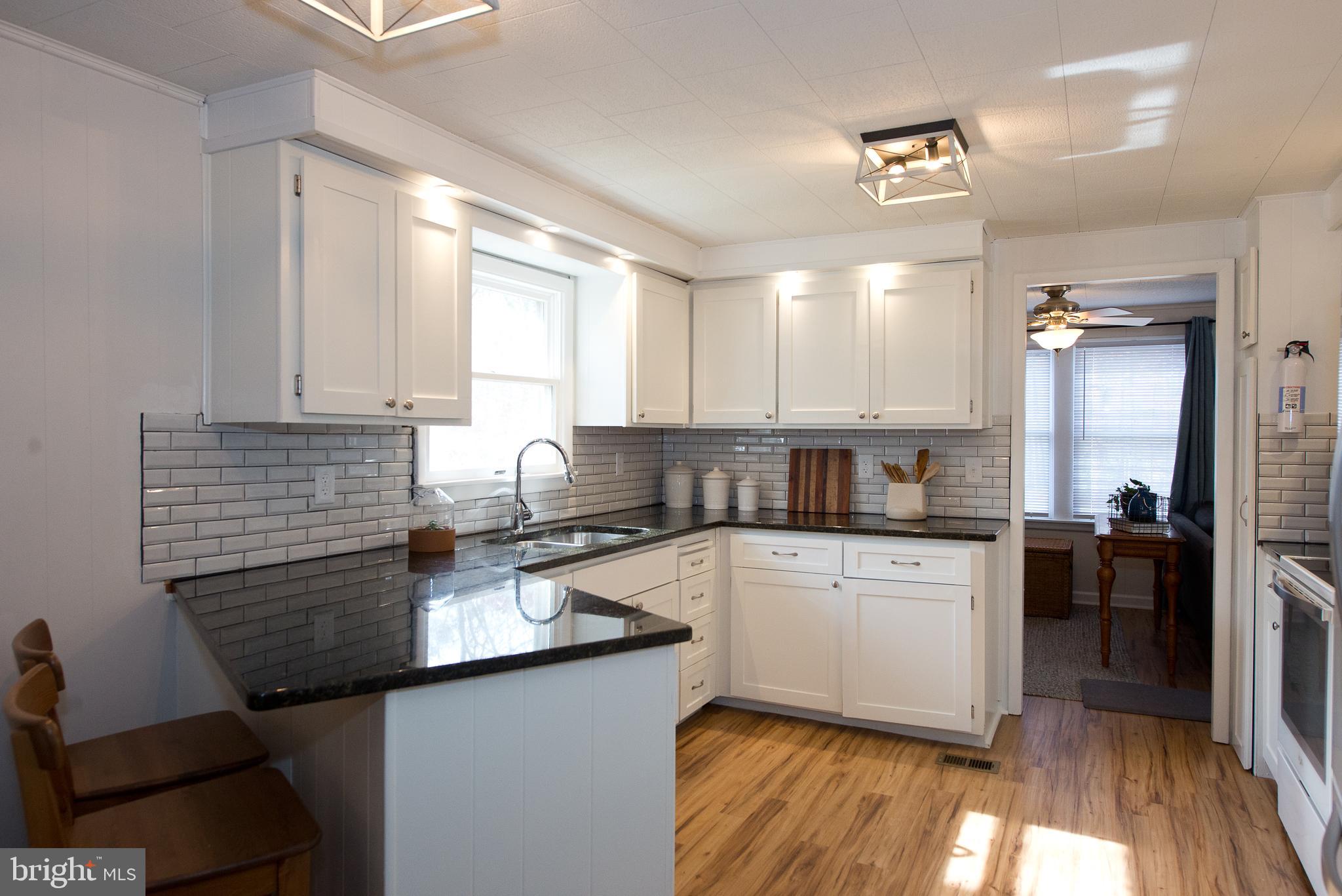22261 Point Lookout Road Leonardtown, MD 20650 - Photo 3 of 33 Kitchen with granite countertops and breakfast bar