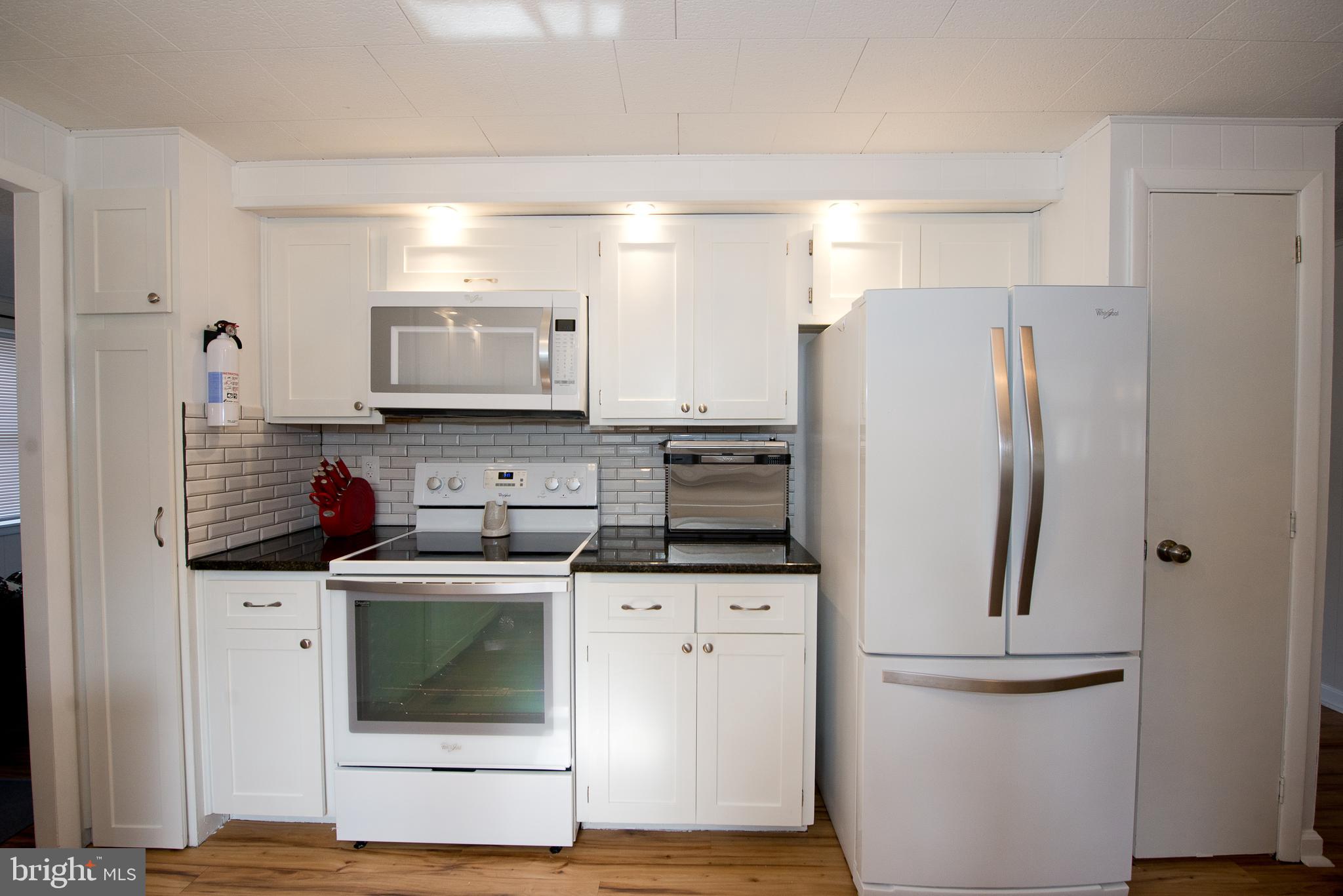 22261 Point Lookout Road Leonardtown, MD 20650 - Photo 6 of 33 Kitchen with fresh paint and plenty of cabinets