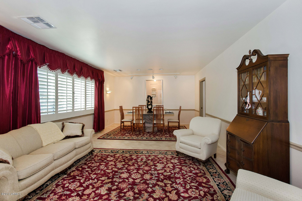 3434 East Camelback Road Phoenix, AZ 85018 - Photo 11 of 31 a living room with furniture and a rug