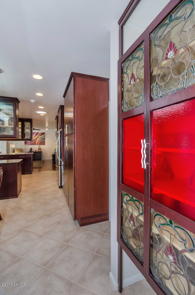 3434 East Camelback Road Phoenix, AZ 85018 - Photo 8 of 31 a kitchen with stainless steel appliances granite countertop a refrigerator and a wooden floor