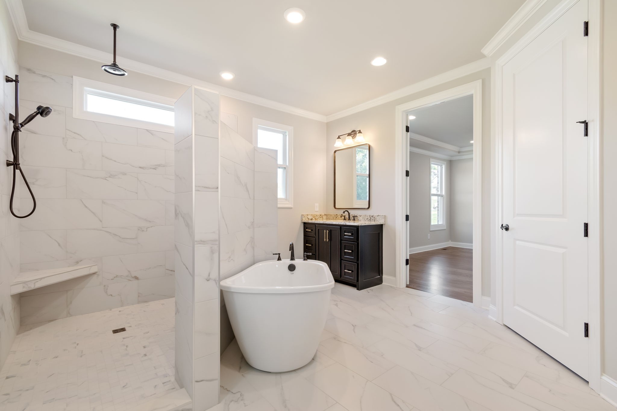 4111 Affiant Way Culleoka, TN 38451 - Photo 17 of 25 a large bathroom with a tub a mirror and a shower