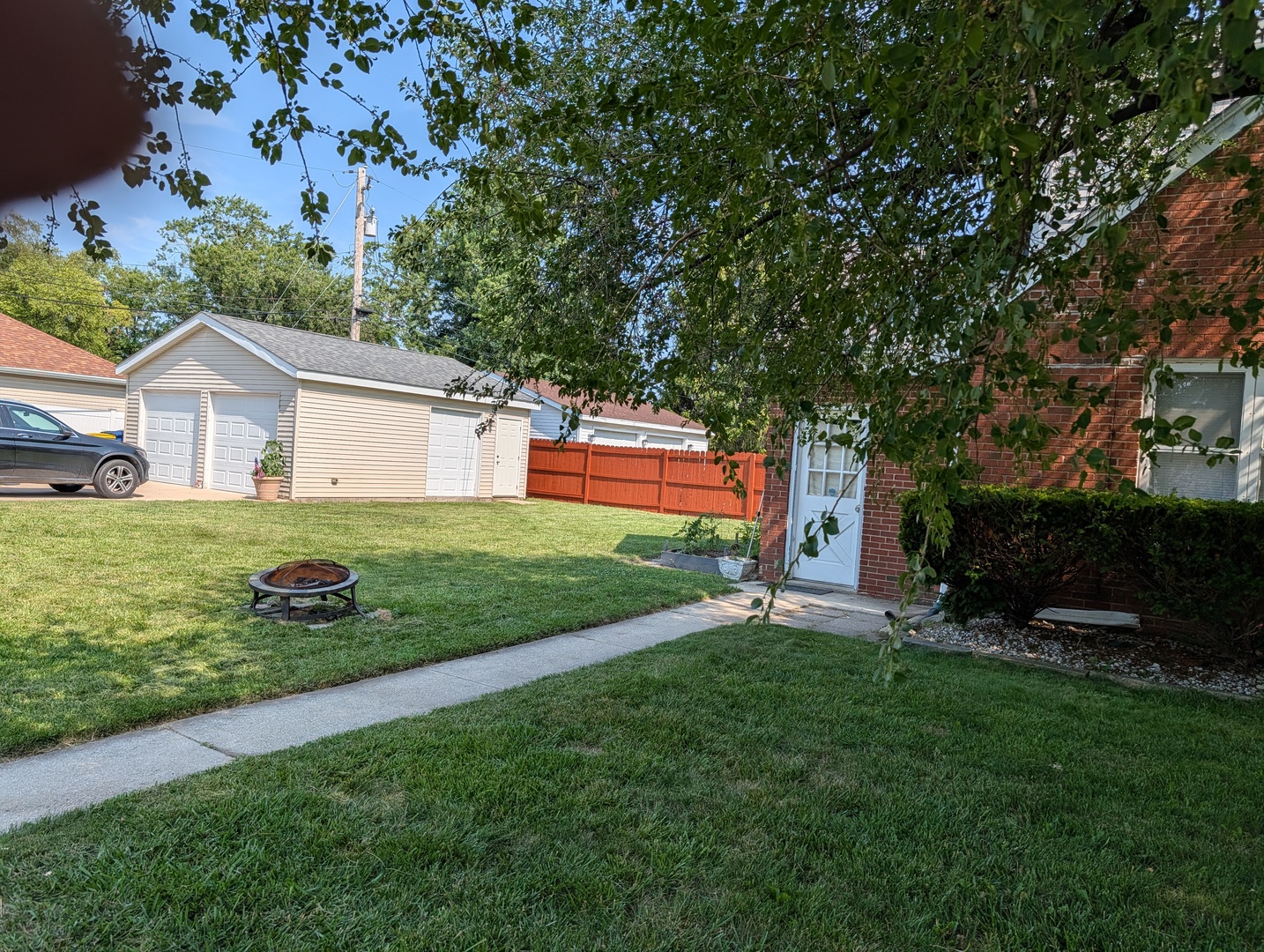 10754 Lyman Avenue Chicago Ridge, IL 60415 - Photo 4 of 17 a front view of a house with a garden and trees