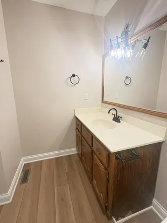 a bathroom with a sink vanity and mirror