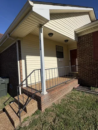 a view of a porch with furniture and floor to ceiling window