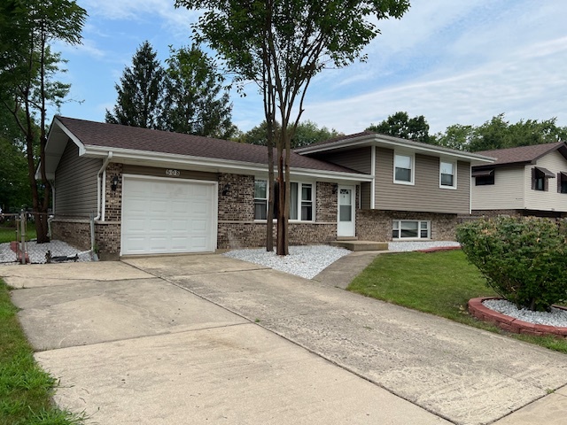 508 Creighton Lane Schaumburg, IL 60193 - Photo 2 of 22 a front view of a house with a yard and garage