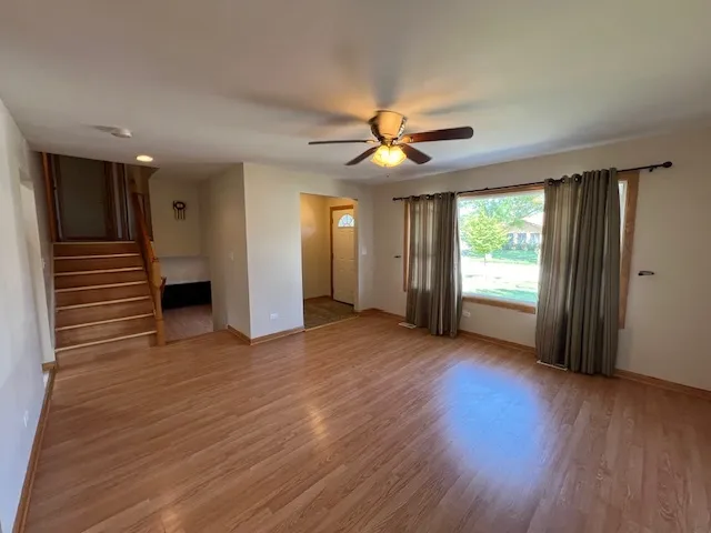 a view of livingroom with hardwood floor and a ceiling fan