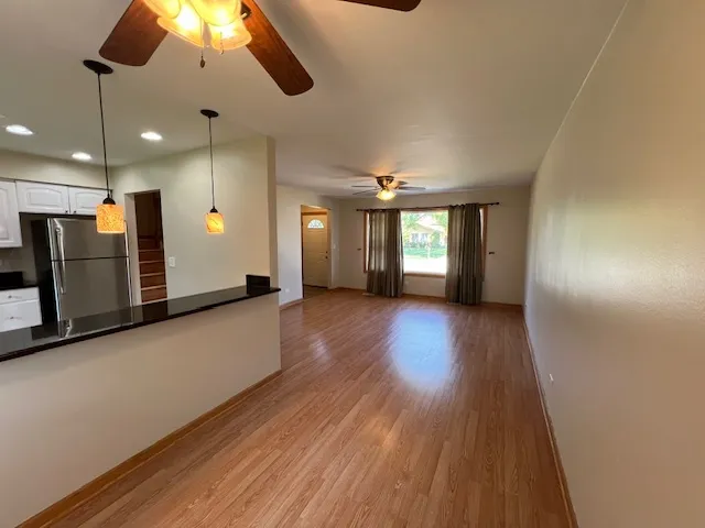 a view of a hallway with wooden floor